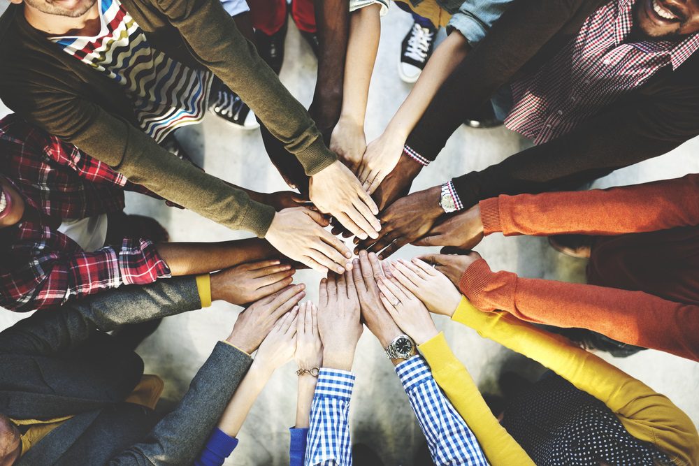 Image of many different hands together in a circle