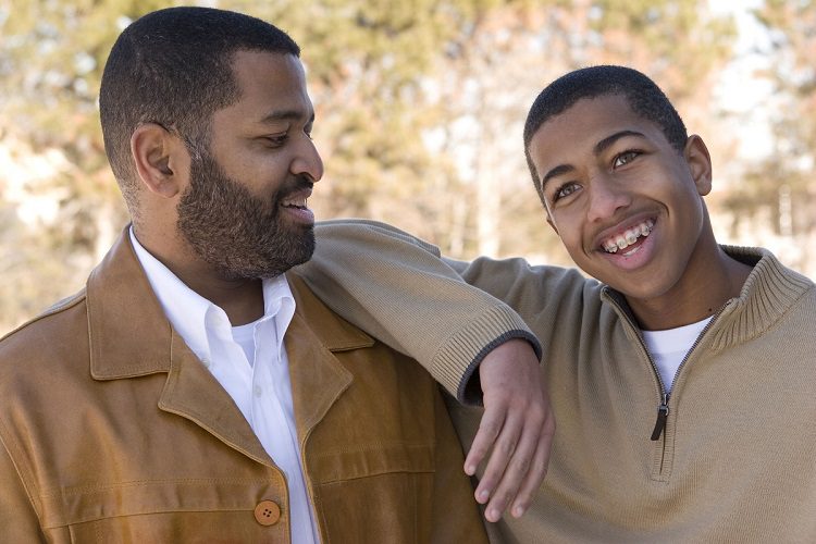 Afroamerican dad and teenager talking