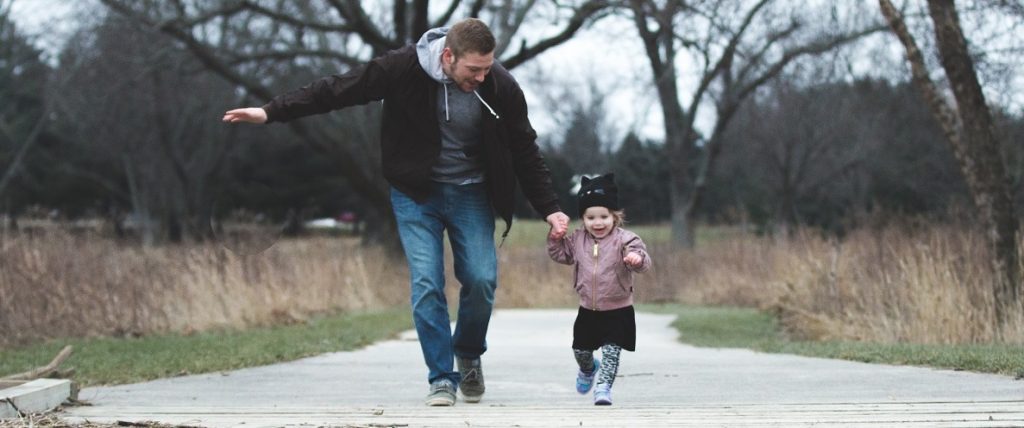 Father running with daughter
